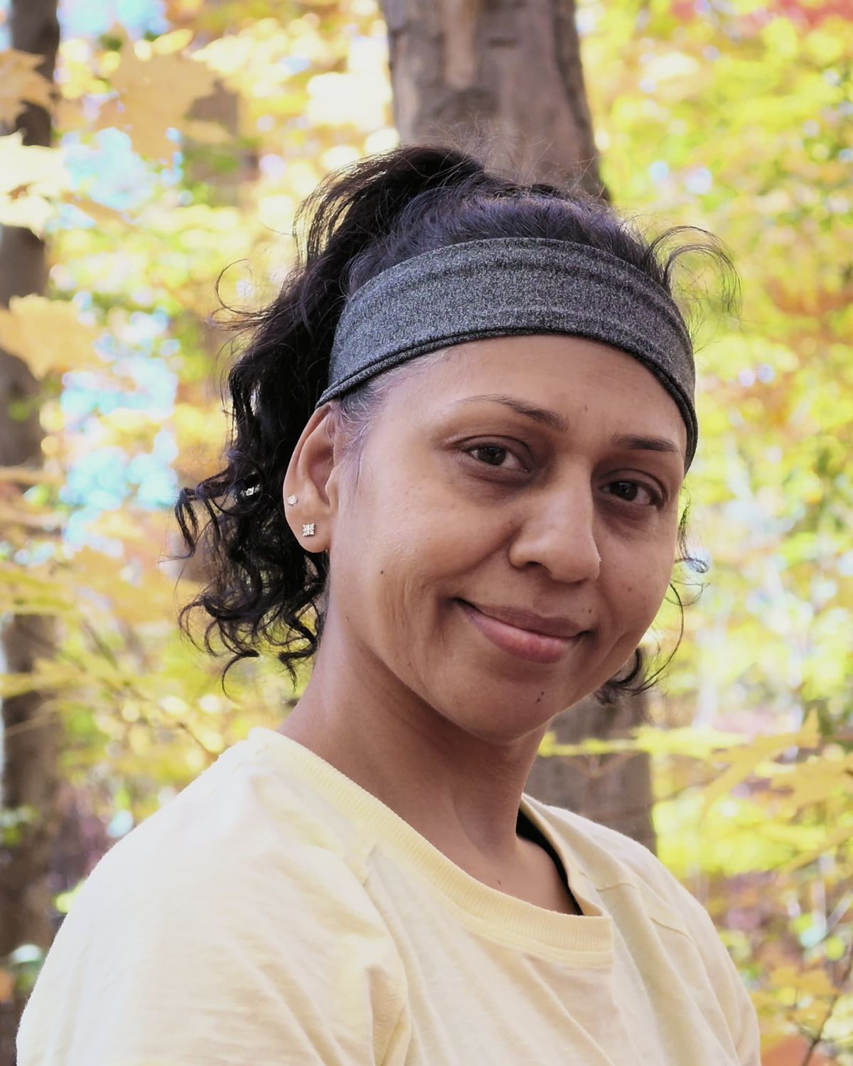 Sneh Lata smiling softly at the camera outdoors